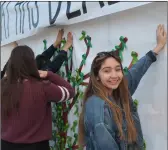  ?? PHOTO ANDY VELEZ ?? Brawley Union High School senior Lexi Tanori, a member of the Mental Health Awareness Club, helps hang the poster for the club’s Mental Health Awareness Week.