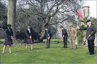  ?? Picture: Dougie Nicolson. ?? Year 10 (third year) pupils receiving a golf lesson from Old Tom Morris aka David Joy, seccond right, with Tom’s caddie Jimmy Bone, right, as pupils (from left) Ellie Hutson, Charlotte Leek, Alasdair Mcdougall and Curtis Stiles swing their hickory clubs.