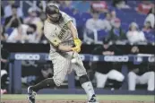  ?? WILFREDO LEE AP PHOTO/ ?? San Diego Padres’ Gary Sanchez hits a home run during the fifth inning of a baseball game against the Miami Marlins on Thursday in Miami.