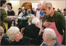  ??  ?? Malik Naveed bin Rehman is greeted by church members at the First Congregati­onal Church of Old Lyme as he serves soup during the church’s Maundy Thursday soup dinner on March 29.
