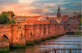  ??  ?? The 153ft (47m) spire of Berwick Town Hall, with its clock tower, rises up among the red-roofed houses beyond the Old Bridge.