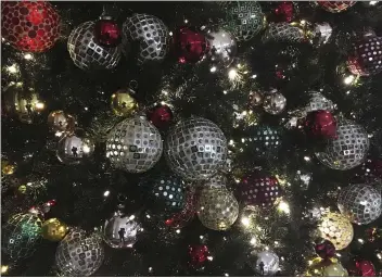  ?? SWAYNE B. HALL — THE ASSOCIATED PRESS FILE ?? Ornaments hang on a Christmas tree on display in New York in December 2017.