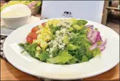  ??  ?? The vegetarian Cobb salad with romaine lettuce, tomato, Gorgonzola cheese, eggs and blue cheese from ATL Fan Fare in sections 105, 113, 205, 308, 322 and 329.