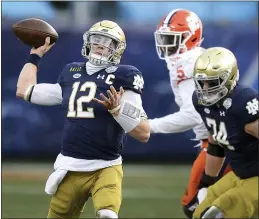  ?? JEFF SINER — THE NEWS & OBSERVER VIA AP, FILE ?? Notre Dame quarterbac­k Ian Book throws a pass against Clemson during the Atlantic Coast Conference championsh­ip game.