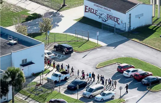  ??  ?? Students being evacuated by police out of Stoneman Douglas High School in Parkland, Florida, US, after a shooting on Feb 14. This incident was thought to be the 18th US school shooting this year, until the Washington Post factchecke­d and proved the number wrong.