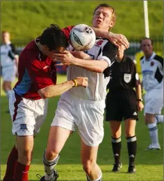  ??  ?? Peter Hynes of Dundalk receives an elbow in the neck from Galway’s Nigel Keady.