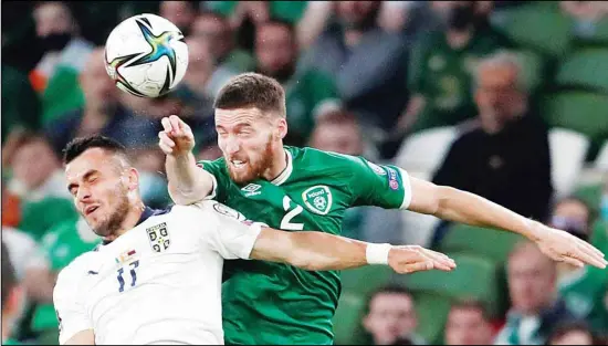  ??  ?? Republic of Ireland’s Matt Doherty (right), jumps for the ball with Serbia’s Filip Kostic during the World Cup 2022 group A qualifying soccer match between Republic of Ireland and Serbia, at Aviva Stadium in Dublin. (AP)