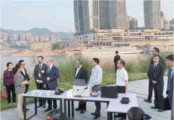  ?? — Reuters ?? German Chancellor Olaf Scholz visits a research project on the monitoring of water quality in Chongqing, China.
