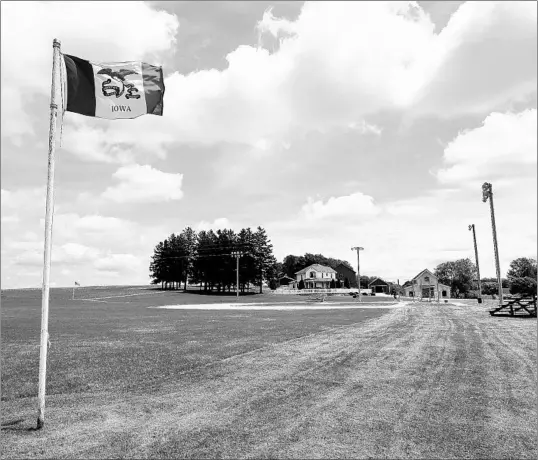  ?? CHARLIE NEIBERGALL/AP ?? An Iowa flag waves in the wind over the field at the Field of Dreams movie site, Friday, June 5, 2020, in Dyersville, Iowa. MLB is hoping to stage a game in the area in August.