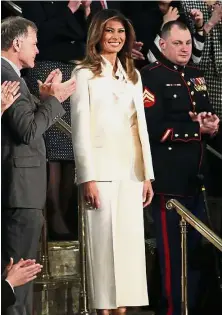  ?? — Reuters ?? An enigmatic figure: Melania smiling as she is mentioned by Trump during his State of the Union address to a joint session of the US Congress on Capitol Hill in Washington.
