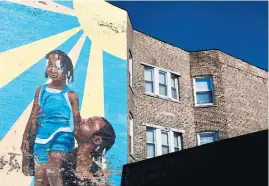  ??  ?? A mural, titled “After the Storm,” is seen on a three flat in the 3500 block of West Madison Street in Chicago’s East Garfield Park neighborho­od. Created in 2010, Brendan Hudson was the principal artist on the mural project.