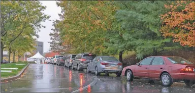  ?? (AP/Record-Journal/Dave Zajac) ?? Motorists line up for drive-thru coronaviru­s testing Friday at MidState Medical Center in Meriden, Conn. Hartford HealthCare, the parent company of MidState, has had a sudden spike in testing demand at all its centers, according to a Hartford HealthCare spokeswoma­n.