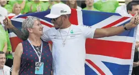  ?? Picture / AP ?? Lewis Hamilton celebrates with his mother, Carmen Larbalesti­er, at the Hermanos Rodriguez track after securing the drivers’ title.