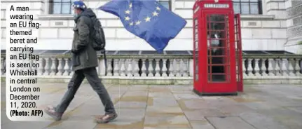  ?? (Photo: AFP) ?? A man wearing an EU flagthemed beret and carrying an EU flag is seen on Whitehall in central London on December 11, 2020.