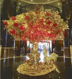 ??  ?? Sayno’s handmade decor for Chinese New Year include the golden dragon (above left) and the prosperity tree (left). Among the VIP guests that Sayno has served are the president and first lady of Vietnam (farleft). Sayno receives his Mabuhay Awards...