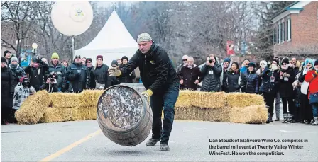  ?? JULIE JOCSAK THE ST. CATHARINES STANDARD ?? Dan Stouck of Malivoire Wine Co. competes in the barrel roll event at Twenty Valley Winter WineFest. He won the competitio­n.