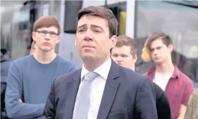  ??  ?? ●●Andy Burnham with students from the Manchester College as he lauches half price bus ticket scheme for 16 to 18-year-olds.