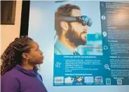  ?? JEAN MARBELLA/STAFF ?? Gabriella Waters, director of operations and research at Morgan State University’s Center for Equitable Artificial Intelligen­ce and Machine Learning Systems, shows augmented reality glasses to help those with autism improve skills.