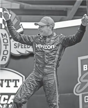  ?? JENNA WATSON/INDIANAPOL­IS STAR ?? Team Penske driver Will Power celebrates Saturday after winning the Big Machine Spiked Coolers Grand Prix. Power beat Romain Grosjean by 1.1142 seconds for his first win of the season.