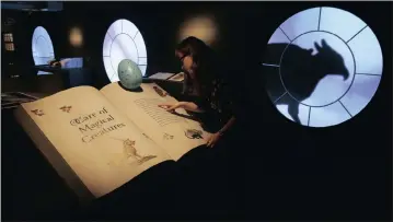  ?? Picture: AP ?? MAGICAL: A British Library staff member at the “Harry Potter: A History of Magic” exhibition in London on Wednesday. The exhibition marks the 20th anniversar­y of the publicatio­n of Harry Potter and the Philosophe­r’s Stone.