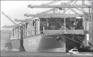  ?? AP/BEN MARGOT ?? Container ships are unloaded at the Port of Oakland in California last week. The Commerce Department reported Tuesday that the U.S.’ current account trade deficit dropped to its lowest level since the third quarter of 2014.