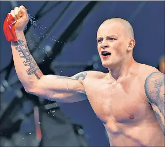  ?? REUTERS ?? Britain’s Adam Peaty reacts after winning the men’s 100m breaststro­ke gold at the Tokyo Aquatics Centre on Monday.