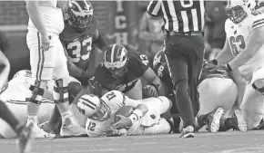  ?? MIKE DE SISTI / MILWAUKEE JOURNAL SENTINEL ?? Badgers quarterbac­k Alex Hornibrook is sacked during Wisconsin’s 14-7 loss to the Michigan Wolverines Oct. 1 at Michigan Stadium in Ann Arbor, Mich.