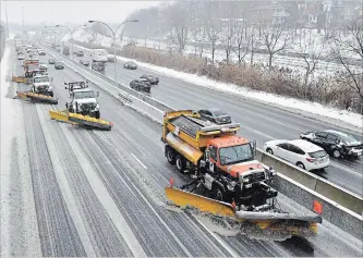  ?? FRANK GUNN THE CANADIAN PRESS ?? A line of snow plows clear the Gardiner Expressway in Toronto on Tuesday after a winter storm hit the region.