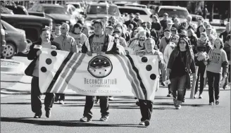  ?? Herald photo by Ian Martens ?? Roy Pogorzelsk­i, Joey Blood and mayor Chris Spearman lead a reconcilia­tion walk from city hall to the Galt Museum as part of the first Reconcilia­tion Week initiative in Lethbridge. @IMartensHe­rald