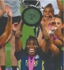  ?? CLIVE BRUNSKILL / AFP / FILES ?? Lyon's Canadian defender Kadeisha Buchanan raises the trophy after the UEFA Women's Champions League final.