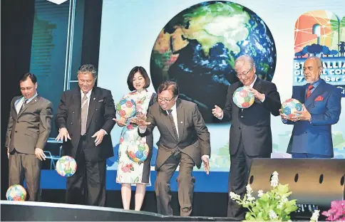  ?? — Bernama photo ?? Abang Johari (third right) joins (from left) Dr Rundi, Morshidi, Pong, Dr Shin and Asfia in bouncing a ‘WHO’ ball as part of the launch gimmick of the AFHC Global Conference and General Assembly.