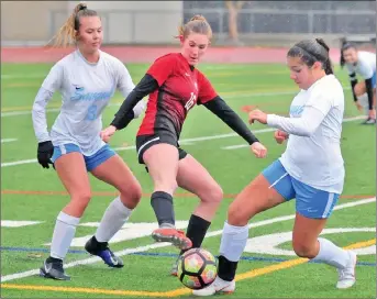  ?? Dan Watson/The Signal (See additional photos on signalscv.com) ?? Hart’s Alyssa Irwin, middle, tries to keep the ball away from Saugus teammates Presley Williams, left, and Abbey Negosian, right, at Hart High School during the 2018-19 season.