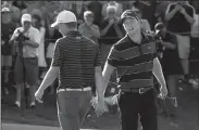  ?? JOHN WOIKE/TRIBUNE NEWS SERVICE ?? In a show of sportsmans­hip, Daniel Berger low-fives Jordan Spieth after Spieth holed a 61 foot bunker shot on the first play hole during the final round of the 2017 Travelers Championsh­ip ProAm on Sunday in Cromwell, Conn.