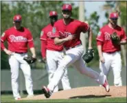  ?? LYNNE SLADKY — THE ASSOCIATED PRESS ?? Philadelph­ia Phillies starting pitcher Aaron Nola works on a drill during baseball spring training camp, Thursday.