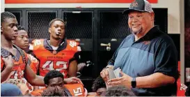  ?? [PHOTO BY SARAH PHIPPS, THE OKLAHOMAN] ?? The Rev. Mike Keahbone, senior pastor of Cherokee Hills Baptist Church, chats with Putnam City High School football players before a game on Sept. 14 at Putnam City Stadium in Oklahoma City.