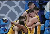  ?? DARRON CUMMINGS — THE ASSOCIATED PRESS FILE ?? Iowa’s Luka Garza (55) hugs a teammate following a second-round game against Oregon in the NCAA Tournament at Bankers Life Fieldhouse on Monday, March 22, in Indianapol­is. Oregon won 95-80.