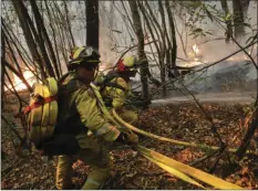  ?? /JAE C. HONG ?? Firefighte­rs put out a hot spot from a wildfire Thursday near Calistoga.