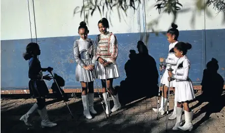  ??  ?? Two leaders in the centre, Runique Lukas and Caslynn De Vos of Bernard Isaacs Primary School Drum Majorettes.
Inset, Nuraan Petersen poses for a picture. Bottom, the majorettes form up. Main picture, Lieyaan Buys tracks her mace in the air.