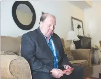  ?? CP PHOTO ?? Rick Brown sits in his living room with a small Bible in Kitchener Ont.