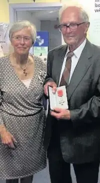  ??  ?? Dennis Jones with the Lord Lieutenant of Mid Glamorgan Kate Thomas, who presented him with his MBE at the CAB office in Bridgend