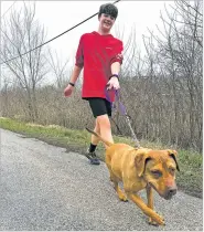  ?? COURTESY JARRIN WILLIAMS VIA THE WASHINGTON POST ?? Rock Island (Illinois) High School freshman Judah Kargl on a run with Nala on March 14.