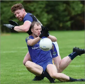  ?? Photo by Michelle Cooper Galvin ?? Spa’s Shane Lynch comes under pressure from Padraig Healy, Glenflesk, in the County Intermedia­te Club Championsh­ip in Glenflesk on Saturday.