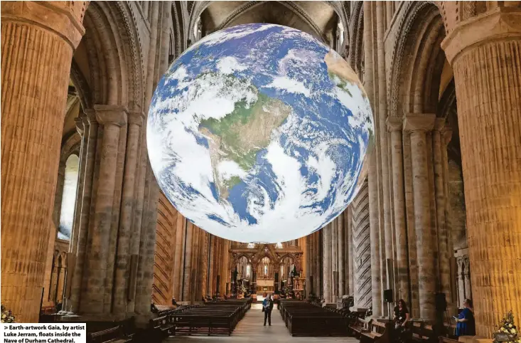  ?? ?? Earth-artwork Gaia, by artist Luke Jerram, floats inside the Nave of Durham Cathedral.