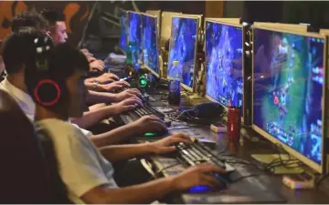  ??  ?? People play online games at an internet cafe in Fuyang, Anhui province, China. — Reuters photo