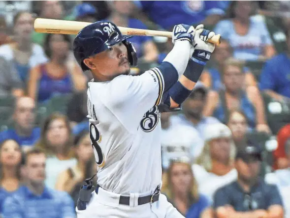  ?? BENNY SIEU/USA TODAY SPORTS ?? Keston Hiura watches his liner clear the wall in right in the 10th inning Saturday night to give the Brewers a comeback victory.