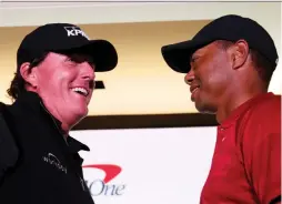  ?? STEVE MARCUS/ASSOCIATED PRESS ?? A lot of the intrigue surroundin­g duelling golfers Phil Mickelson and Tiger Woods figures to be the extent of the pay-per-audience for their Friday challenge match in Las Vegas.