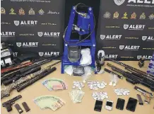  ??  ?? More than $62,000 worth of drugs, along with firearms, cash, a Taser and brass knuckles, was seized by ALERT members. Four people are charged.