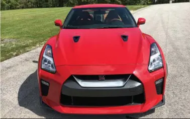  ?? (Robert Duffer/Chicago Tribune/TNS) ?? The Nissan GT-R in solid red, updated for 2017, is an AWD-supercar with a 565-horsepower twin-turbo V-6 engine that is stunning on the track and comfortabl­e on the road. Pictured at Road America in Elkhart Lake, Wisc., on May 25, 2017.