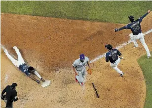  ?? DAVID J. PHILLIP THE ASSOCIATED PRESS ?? The Tampa Bay Rays’ Randy Arozarena scores the winning run against the Los Angeles Dodgers in Game 4 of the World Series on Saturday.