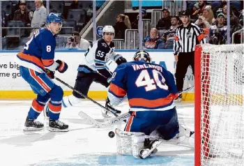  ?? ?? Islanders goalie Semyon Varlamov stops a third-period shot by the Jets’ Mark Scheifele at UBS Arena in Elmont on Saturday. Varlamov had 33 saves in the win.